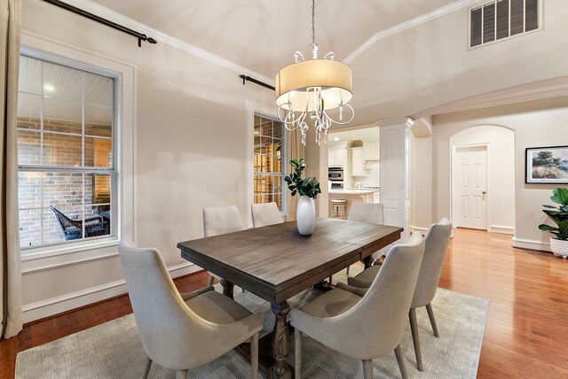 dining room featuring a chandelier, visible vents, light wood finished floors, and baseboards