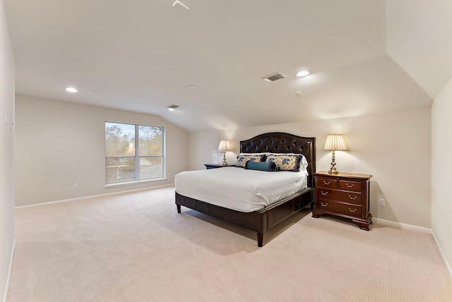 bedroom with vaulted ceiling, light carpet, visible vents, and baseboards