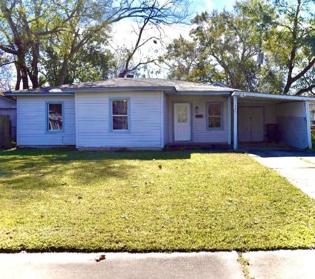 single story home with an attached carport, concrete driveway, and a front lawn