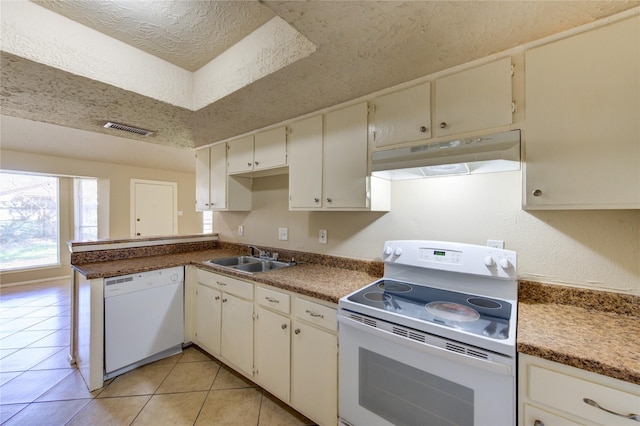 kitchen featuring white appliances, visible vents, a textured ceiling, under cabinet range hood, and a sink