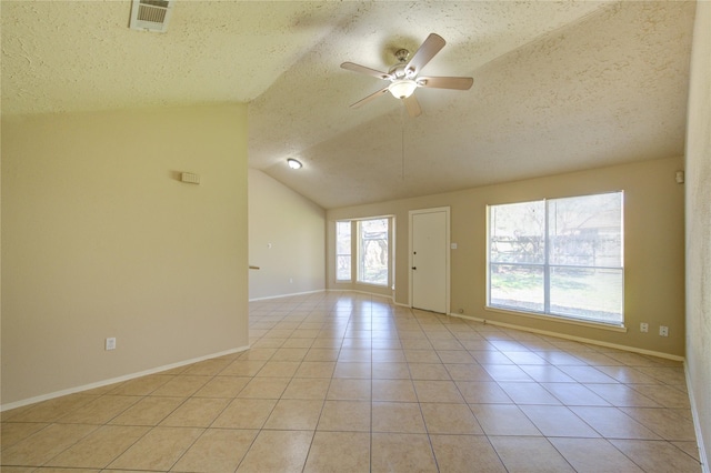 spare room with light tile patterned floors, ceiling fan, a textured ceiling, lofted ceiling, and visible vents