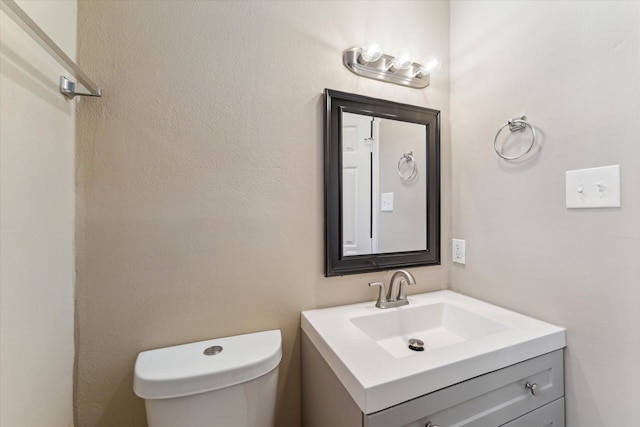 bathroom featuring toilet and vanity