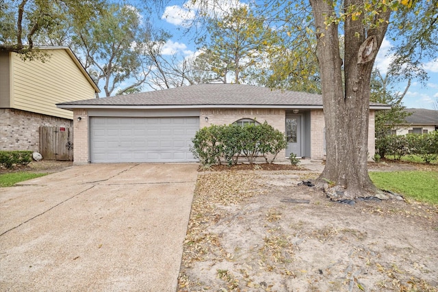 view of front of house featuring concrete driveway, an attached garage, and brick siding