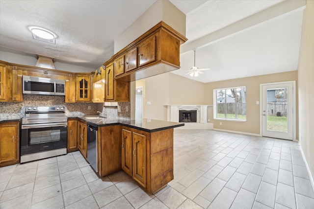 kitchen featuring backsplash, vaulted ceiling with beams, appliances with stainless steel finishes, and brown cabinetry