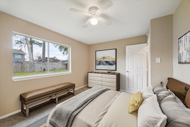 carpeted bedroom with baseboards and a ceiling fan