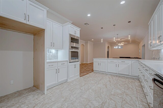 kitchen featuring visible vents, arched walkways, white cabinets, a peninsula, and stainless steel appliances