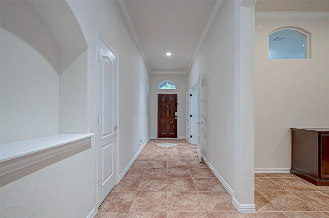 entryway with baseboards, recessed lighting, visible vents, and crown molding