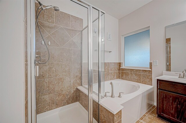 bathroom featuring a bath, a shower stall, vanity, and tile patterned floors