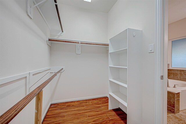 spacious closet with wood finished floors