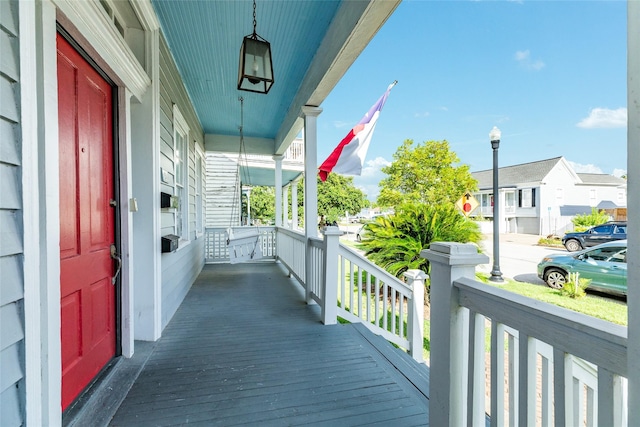 wooden terrace with a porch and a residential view