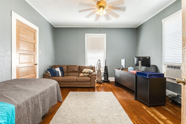 home office with cooling unit, crown molding, a ceiling fan, and wood finished floors