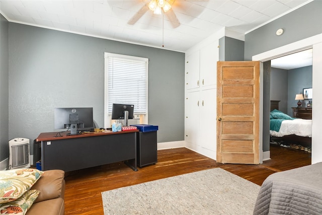 home office featuring baseboards, wood finished floors, a ceiling fan, and crown molding