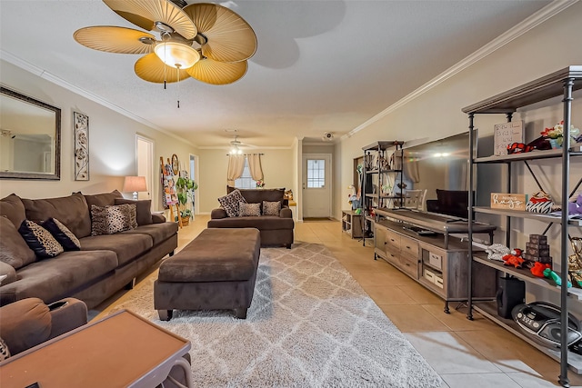 living room featuring light tile patterned floors, ornamental molding, and a ceiling fan