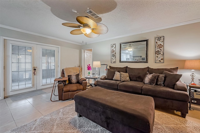 living area featuring french doors, crown molding, light tile patterned flooring, ceiling fan, and a textured ceiling