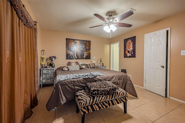 bedroom with light tile patterned flooring, a ceiling fan, and baseboards