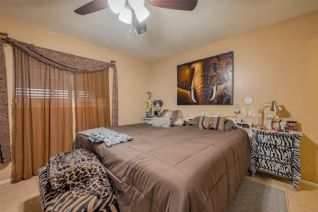 bedroom featuring tile patterned flooring, baseboards, and ceiling fan