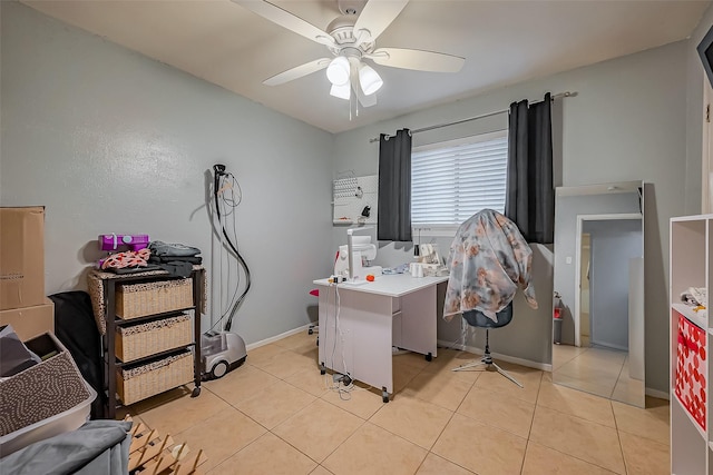 interior space with a ceiling fan, baseboards, and light tile patterned floors