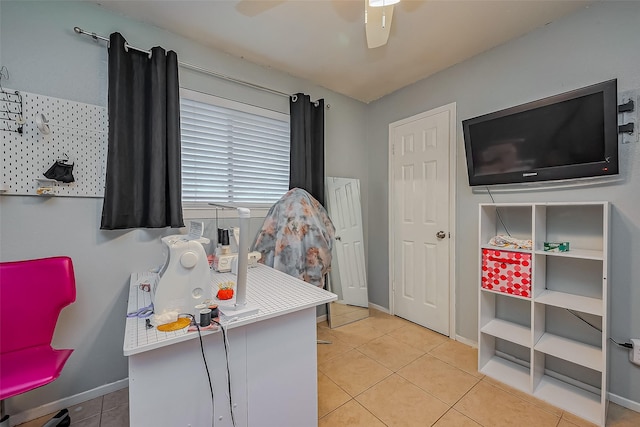 office featuring tile patterned flooring, a ceiling fan, and baseboards