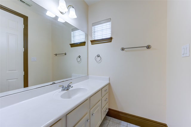 bathroom with visible vents, baseboards, vanity, and tile patterned floors