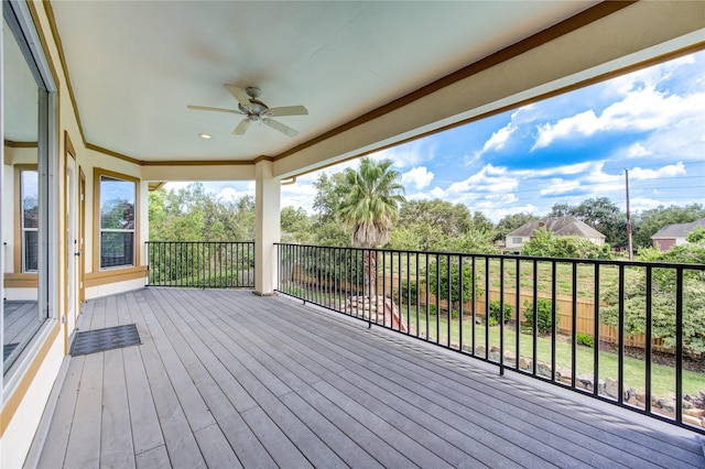 wooden terrace featuring a ceiling fan