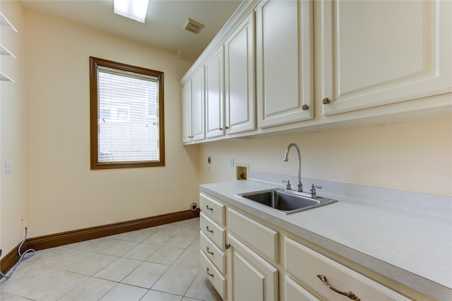 clothes washing area featuring hookup for an electric dryer, washer hookup, a sink, visible vents, and cabinet space