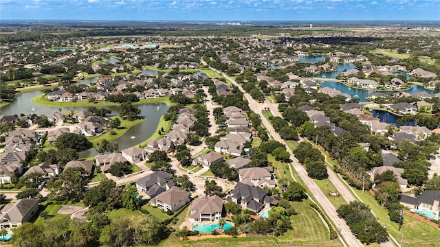 birds eye view of property featuring a water view and a residential view