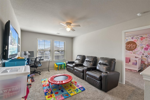 living area with a textured ceiling, ceiling fan, carpet, and baseboards