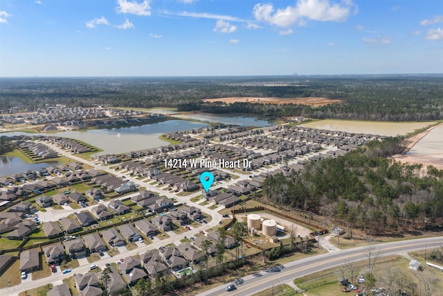 birds eye view of property with a water view and a residential view