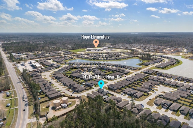 birds eye view of property featuring a water view and a residential view