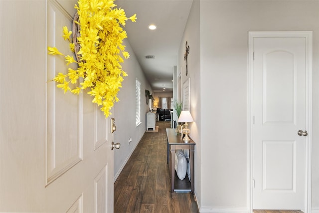 hall with recessed lighting, dark wood-style flooring, visible vents, and baseboards