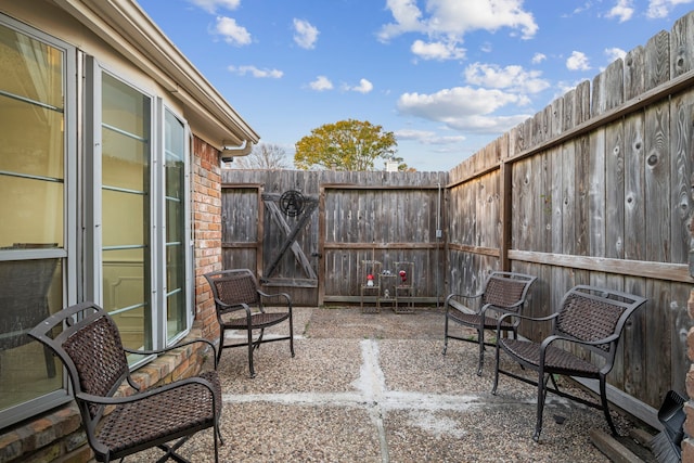 view of patio with a gate and fence