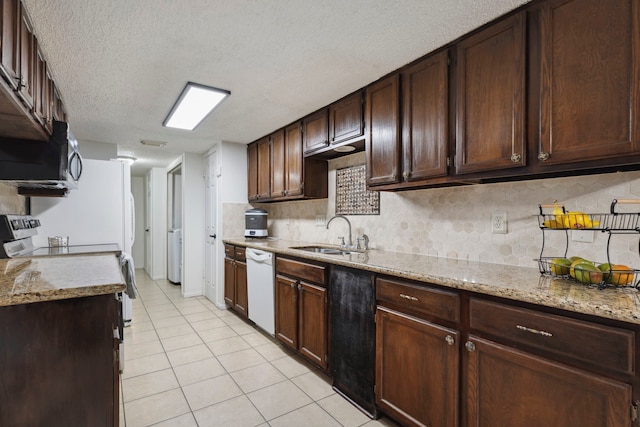 kitchen with light tile patterned floors, stainless steel microwave, decorative backsplash, a sink, and dishwasher