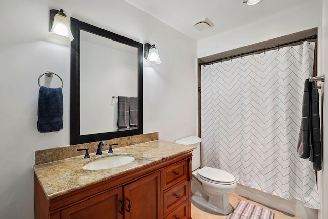 full bathroom featuring toilet, shower / tub combo, and vanity