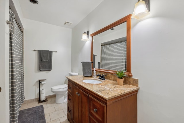 full bath with vanity, toilet, and tile patterned floors