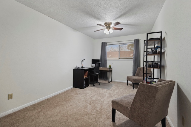 carpeted office with ceiling fan, a textured ceiling, and baseboards