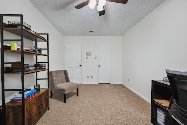 living area featuring baseboards, visible vents, ceiling fan, a textured ceiling, and carpet floors