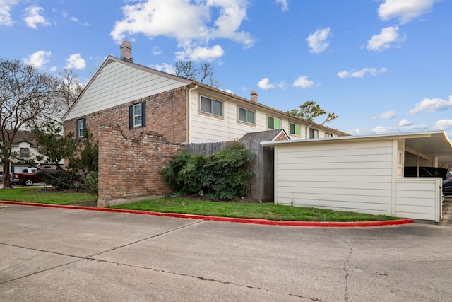 view of side of home with brick siding