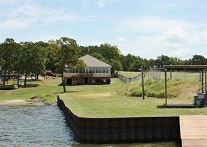 view of property's community featuring a water view and a yard