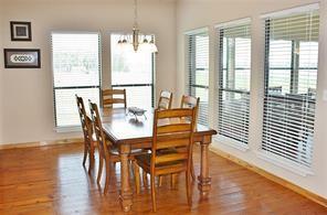 dining space with an inviting chandelier, baseboards, and wood finished floors
