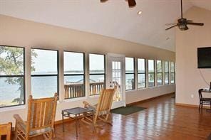 sunroom featuring a ceiling fan and vaulted ceiling