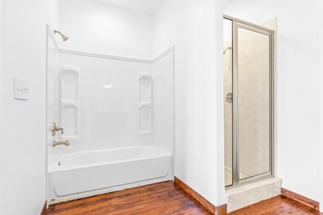 6930 W County Road 372, Jewett, TX 75846 - bathroom featuring wood finished floors, washtub / shower combination, and baseboards