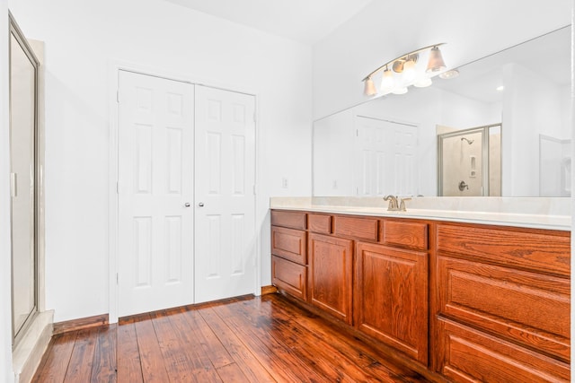 full bathroom featuring a shower stall, hardwood / wood-style floors, and vanity