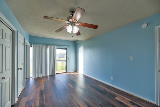 spare room featuring ceiling fan, a textured ceiling, baseboards, and wood finished floors