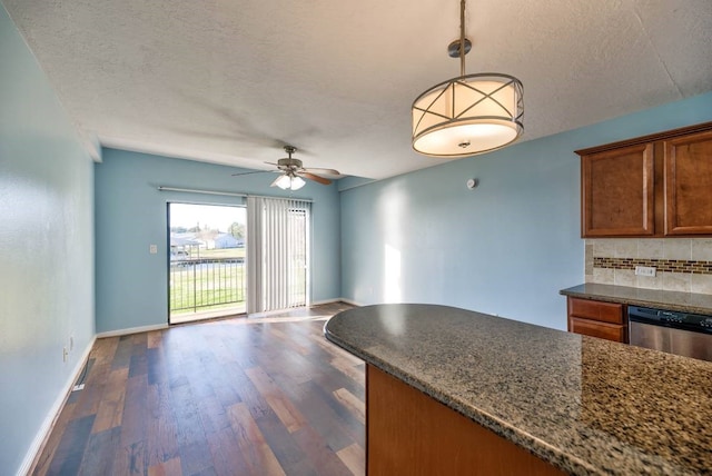 kitchen with tasteful backsplash, baseboards, dark wood-style flooring, a textured ceiling, and stainless steel dishwasher