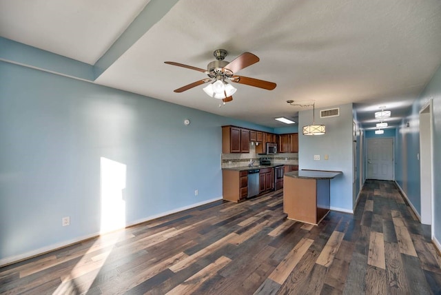 kitchen featuring baseboards, visible vents, stainless steel appliances, and dark wood-style flooring