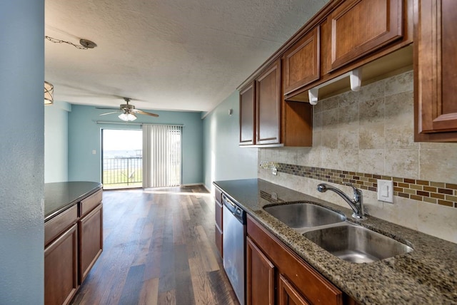 kitchen featuring a sink, stainless steel dishwasher, backsplash, brown cabinets, and dark wood-style floors