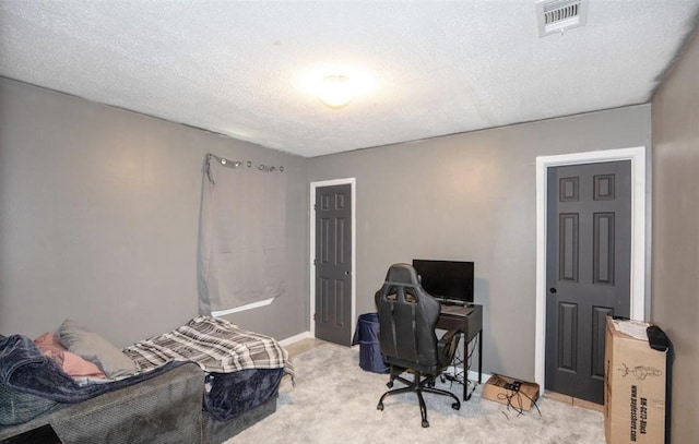 carpeted bedroom featuring a textured ceiling and visible vents