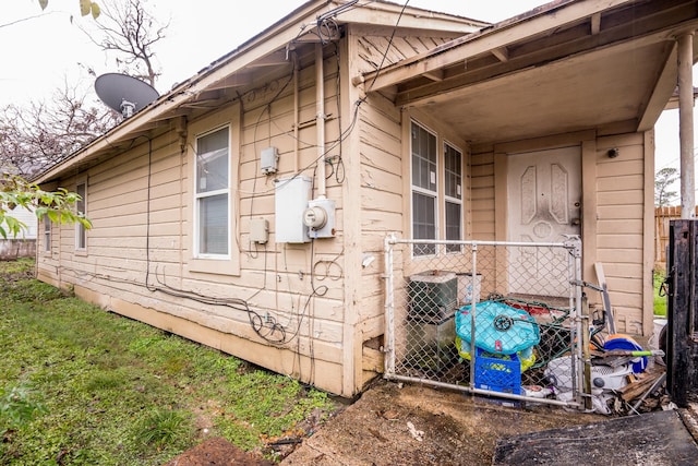 view of side of home featuring fence