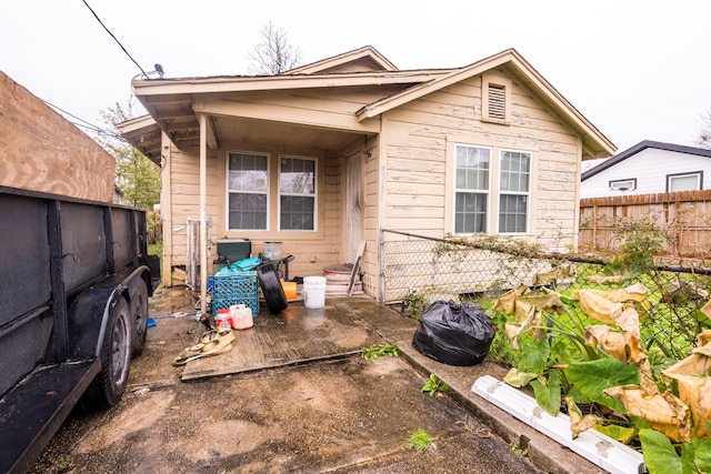 rear view of house featuring fence