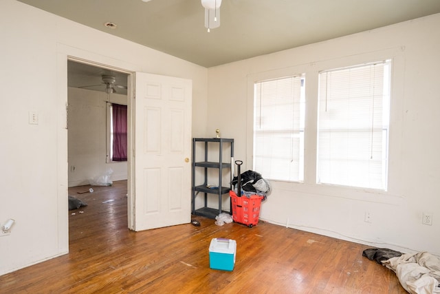 misc room with a healthy amount of sunlight, hardwood / wood-style flooring, and a ceiling fan